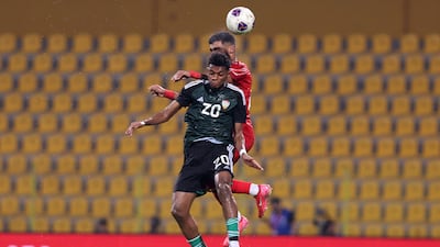 UAE's Yahya Al Ghassani goes up for a header.