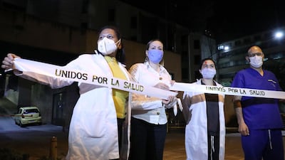 Health workers attend a rally in support of Colombian doctor Jose Buelvas Diaz outside the San Ignacio Hospital in Bogota, Colombia. Buelvas Diaz has reportedly received anonymous threats after one of his patients died with Covid-19 in Barranquilla, north of Colombia. EPA