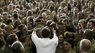 US President Barack Obama greets troops at Bagram Air Base in Kabul. Mr Obama and Hamid Karzai, the Afghan President, signed the Strategic Partnership Agreement at the Presidential Palace.