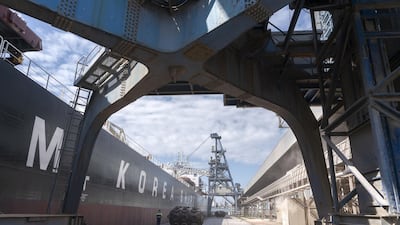 An employee walks on a grain terminal while loading corn grain into a vessel in the trade port of Constanta, Romania.