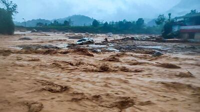 This handout photograph taken on July 30, 2024 and released by India's National Disaster Response Force (NDRF) shows a damaged car at the landslide site in Wayanad. The southern coastal state of Kerala has been battered by torrential downpours, and the collapse of a key bridge at the disaster site in Wayanad district has hampered rescue efforts, according to local media reports. (Photo by National Disaster Response Force (NDRF) / AFP) / XGTY / RESTRICTED TO EDITORIAL USE - MANDATORY CREDIT "AFP PHOTO / India's National Disaster Response Force (NDRF)" - NO MARKETING NO ADVERTISING CAMPAIGNS - DISTRIBUTED AS A SERVICE TO CLIENTS
