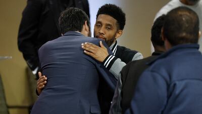 Mr Scott, centre, hugs an attendee during a vigil for victims of the bridge collapse at the Mount Olive Baptist Church in Baltimore. AFP