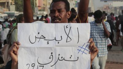 A Sudanese protester holds a placard during a rally in the capital Khartoum to condemn the "massacre" of five demonstrators including four high school students at a rally in a central town of Al-Obeida. AFP