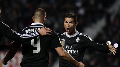 Real Madrid's Cristiano Ronaldo, right, and Karim Benzema celebrate after Benzema's goal in Madrid's 2-0 La Liga victory on Sunday. Jose Jordan / AFP / February 22, 2015