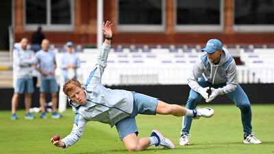 Ollie Pope of England catches as Joe Root look on in London. Getty