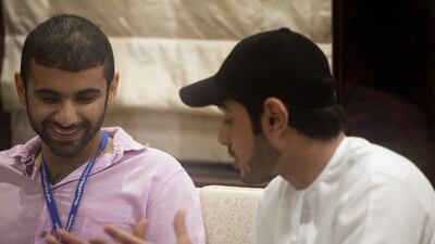 Sheikh Mansour bin Mohammed bin Rashid, centre, and Sheikh Mohammed bin Sultan bin Hamdan, right, attend the Abu Dhabi Media Racing Lounge and yacht in Yas Marina during the Etihad Airways Formula One Abu Dhabi Grand Prix.