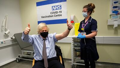 Britain's Prime Minister Boris Johnson gestures after receiving the first dose of the AstraZeneca vaccine at St.Thomas' Hospital in London in March this year. AP Photo