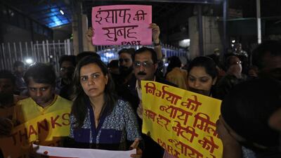 People stand outside Tihar jail during the execution of four men sentenced to death for the fatal assault on a 23-year-old woman aboard a bus in the Indian capital on December 16, 2012. AP Photo
