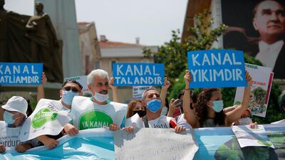 Demonstrators in Istanbul hold a placard that reads '"Canal is destructıon' during a protest in Istanbul, on Saturday, June 26, 2021. AP Photo
