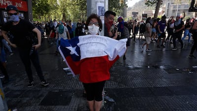 A woman holds a Chilean flag. Getty Images