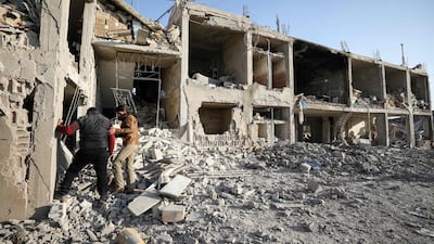 Men inspect the rubble of a hospital that was reportedly hit by an airstrike in the Syrian village of Shinan, about 30 kilometres south of Idlib in the northwestern Idlib province. AFP