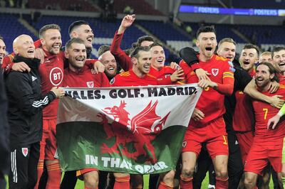 Gareth Bale celebrates with his Welsh teammates with the flag which has offended real Madrid fans. Getty