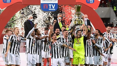 Juventus' Italian goalkeeper Gianluigi Buffon holds the winner's trophyafter winning the final of the Coppa Italia against Atalanta. AFP