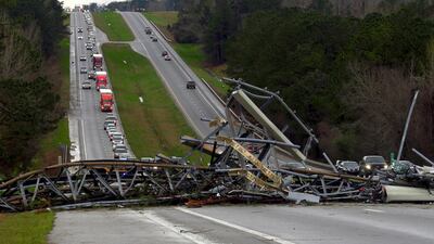 A fallen cell tower lies across a highway in Lee County, Alabama. AP Photo
