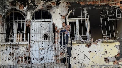 Sahin Donmez surveys the damage to his house on November 14, 2015 after almost two weeks of street battles between Kurdish militants and Turkish security forces in the southeastern town of Silvan, as Ankara pursues "anti-terror" operations against suspected militants allied to the outlawed Kurdistan Workers Party (PKK). Ilyas Akengin/AFP Photo