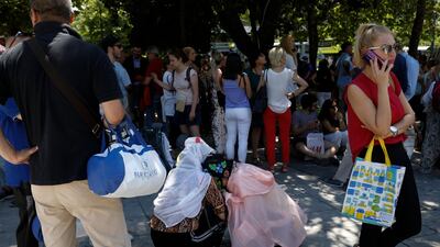 Tourist hug each other in Syntagma square after a strong earthquake hit near the Greek capital of Athens, Friday, July 19, 2019. The Athens Institute of Geodynamics gave the earthquake a preliminary magnitude of 5.1 but the U.S. Geological Survey gave it a preliminary magnitude of 5.3. The Athens Institute says the quake struck at 2:38 p.m. local time (1113 GMT) about 26 kilometers (13.7 miles) north of Athens. (AP Photo/Petros Giannakouris)