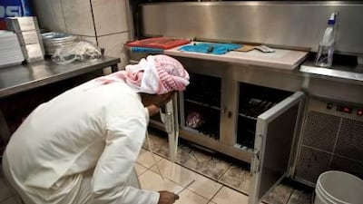 An inspector from the Abu Dhabi Food Control Authority inspects the kitchen of a restaurant. The ADFCA hopes to have all food-outlet staff training in hygiene by 2013.