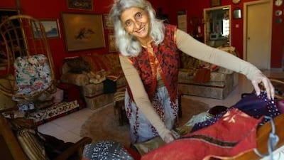 Tasleem Karmali in her Karama flat with one of the outfits she has designed and made from leftover material, which will be sold for charity.