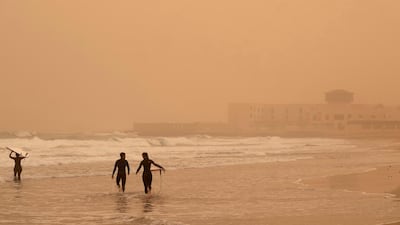 Surfers go for a swim at Playa Blanca in Puerto del Rosario, Fuerteventura, Canary Islands. EPA