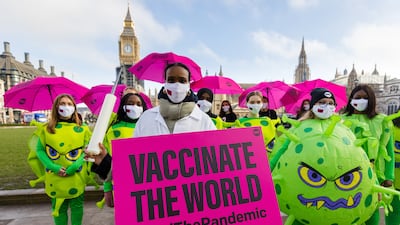 Activists from anti-poverty organisation the ONE Campaign call for the sharing of coronavirus vaccines with developing countries, in Parliament Square in London. EPA