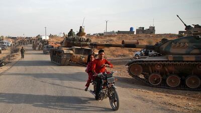 Syrian Arab civilians flee as Turkish troops with American-made M60 tanks and Turkish-backed Syrian fighters gather near the village of Qirata on the outskirts of the northern city of Manbij near the Turkish border. Turkey wants to create a roughly 30-kilometre (20-mile) buffer zone along its border to keep Kurdish forces at bay and also to send back some of the 3.6 million Syrian refugees it hosts. AFP