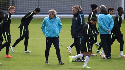 Manuel Pellegrini conducts a Manchester City training session. Paul Ellis / AFP