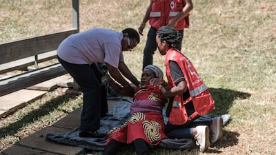 Kenya Red Cross staff assist a grieving woman at the Chiromo Mortuary in Nairobi on January 17, 2019. AFP