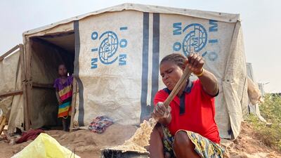 A woman cooks food at a camp for internally displaced people in Nigeria, where at least 13 million are going hungry. AP
