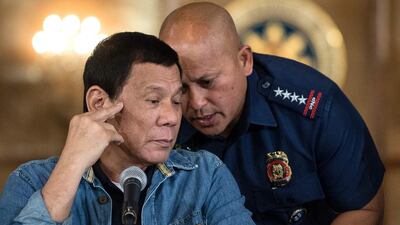 Philippine president Rodrigo Duterte, left, talks to Philippine National Police director general Ronald Dela Rosa during a press conference at the Malacanang palace in Manila on January 30, 2017. The president has extended his deadly drug war until the last day of his term in 2022, but conceded the police force acting as his frontline troops was "corrupt to the core". Noel Celis/AFP