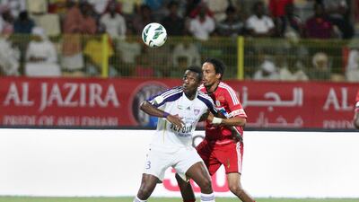 Asamoah Gyan battles for the ball against Al Jazira's Juma Abdulla. (Jaime Puebla / The National)