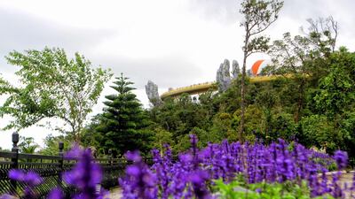 The Golden Bridge is seen past flowers and a line of trees. AFP Photo