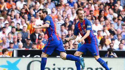 Lionel Messi, left, of FC Barcelona celebrates with his teammate Ivan Rakitic after scoring. David Ramos / Getty Images