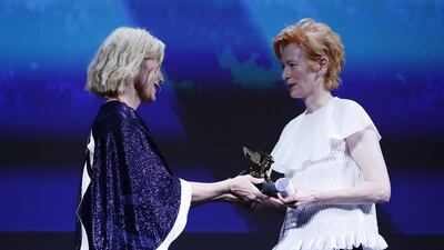 Tilda Swinton is presented with the Golden Lion Lifetime Award by Cate Blanchett during the Opening Ceremony. Getty Images