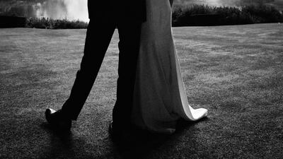 This photo released by Kensington Palace, shows the photo taken by Chris Allerton of Britain's Prince Harry and Meghan, Duchess of Sussex at their wedding reception at Frogmore House, Windsor, England, which is to be used as their 2018 Christmas card. AP