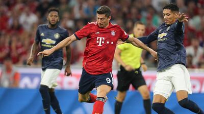 Bayern Munich's Robert Lewandowski holds off Manchester United's Chris Smalling. Getty Images