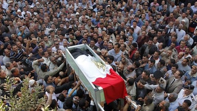 Egyptian mourners carry the coffin of Ahmed Kamal, one of two policemen who was killed in a bomb attack, during his funeral on November 6 in Menufiya province, north of Cairo. Sameh Abouhasan / AFP