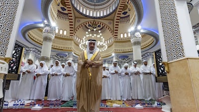 Worshippers begin Eid Al Adha with the morning prayer, at Al Farooq Omar bin Al Khattab Mosque. Antonie Robertson / The National