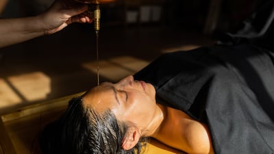 Head massages, which promote scalp health and naturally lustrous hair, are at the core of Ayurvedic beauty rituals. Getty Images
