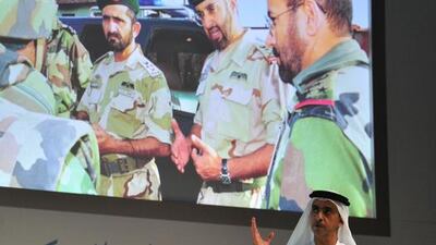 Sheikh Saif bin Zayed addresses the Government Summit yesterday against an archive photo backdrop of Sheikh Mohammed bin Rashid and Sheikh Mohammed bin Zayed on military duty. Courtesy Security Media