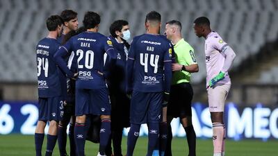 The referee Manuel Mota speaks with players of Belenenses before calling the match off in the 48th minute. EPA