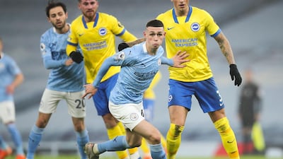 Manchester City's English midfielder Phil Foden on the ball during the English Premier League football match between Manchester City and Brighton and Hove Albion at the Etihad Stadium in Manchester, north west England, on January 13, 2021. RESTRICTED TO EDITORIAL USE. No use with unauthorized audio, video, data, fixture lists, club/league logos or 'live' services. Online in-match use limited to 120 images. An additional 40 images may be used in extra time. No video emulation. Social media in-match use limited to 120 images. An additional 40 images may be used in extra time. No use in betting publications, games or single club/league/player publications. / AFP / POOL / Clive Brunskill / RESTRICTED TO EDITORIAL USE. No use with unauthorized audio, video, data, fixture lists, club/league logos or 'live' services. Online in-match use limited to 120 images. An additional 40 images may be used in extra time. No video emulation. Social media in-match use limited to 120 images. An additional 40 images may be used in extra time. No use in betting publications, games or single club/league/player publications.