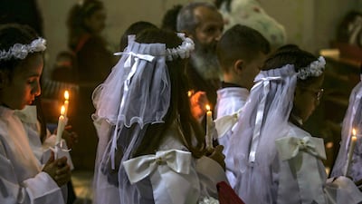 Christian Palestinian children hold candles at a service at the Latin Church in Gaza city. EPA
