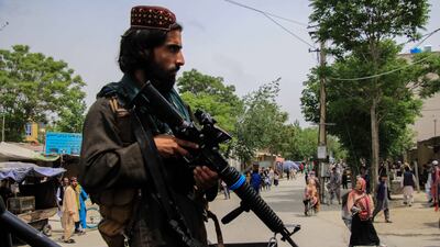A Taliban fighter stands guard near the school in the Dasht e Barchi area of west Kabul. EPA