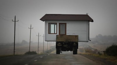 A family drives a truck loaded with a small house along a road as they leave their home village in the separatist region of Nagorno-Karabakh. AP Photo