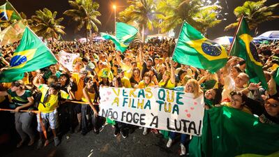 Supporters of Jair Bolsonaro celebrate in front of his house in Rio de Janeiro. Getty Images