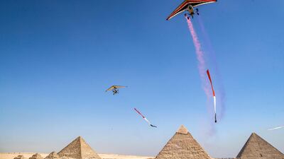 'Ultralight trikes' fly during the Pyramids Air Show.