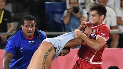 Samoa's wing Ed Fidow, centre, fights with Russia's wing German Davydov. AFP