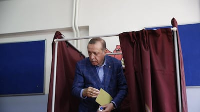 President Recep Tayyip Erdogan leaves a voting booth inside a polling station in Istanbul. Voters in Turkey were casting their ballots in a referendum to approve or reject a set of constitutional reforms that would greatly expand the president's powers. Lefteris Pitarakis / AP Photo