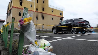 Flowers and other offerings are pictured near the Kyoto Animation Company studio where at least 33 people died in a fire. AFP