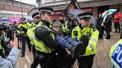 A protester is removed by police in Leeds. AFP